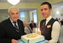 Former Bournemouth Rotary president John Bowen is presented with a Rotary cake to mark his 103rd birthday