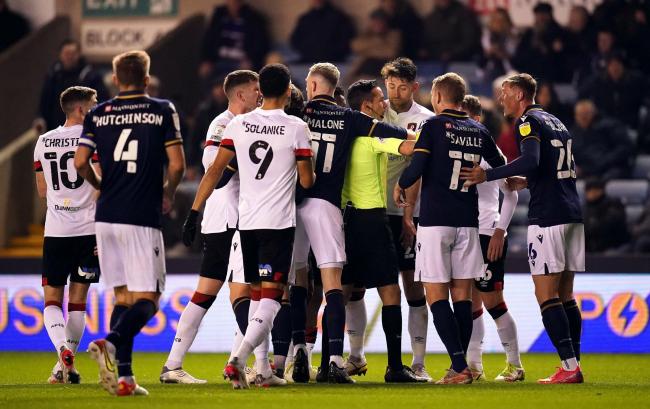 Referee Dean Whitestone breaks up players from both teams as tempers flare during the Sky Bet Championship match at The Den, London. Picture date: Wednesday November 24, 2021. PA Photo. See PA Story SOCCER Millwall. Photo credit should read: John