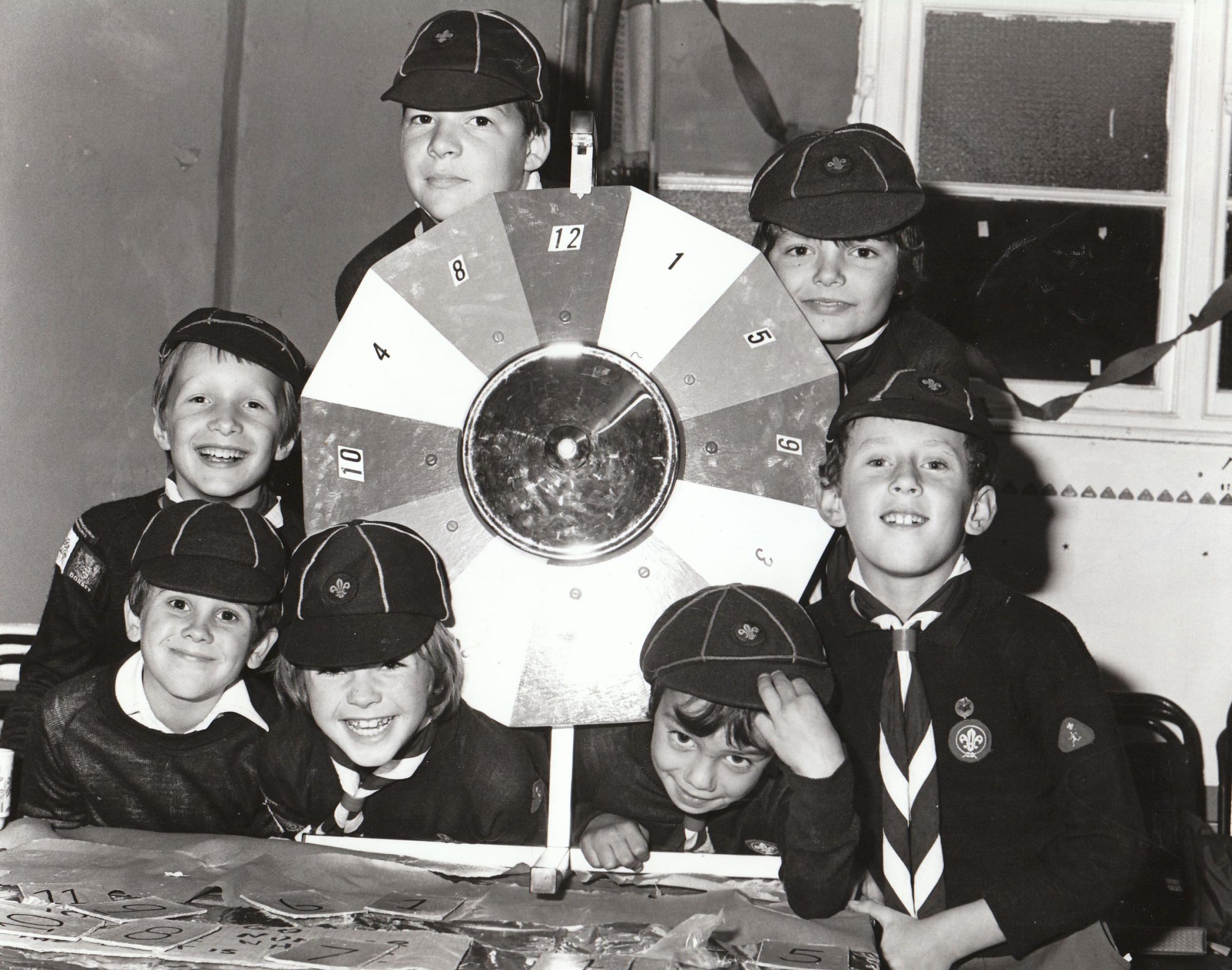 In Nov 1980 These Somerford Cub Scouts spinned the wheel of fortune for visitors at their Christmas fair.