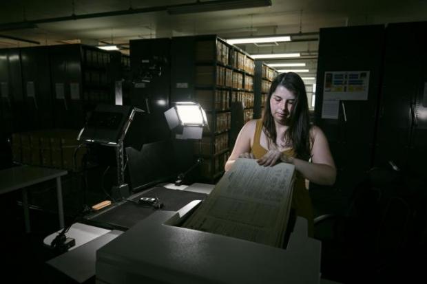 Bournemouth Echo: Photo via PA shows Findmypast technician Laura Gowing scans individual pages of the 30,000 volumes of the 1921 Census at the Office for National Statistics (ONS) near Southampton.