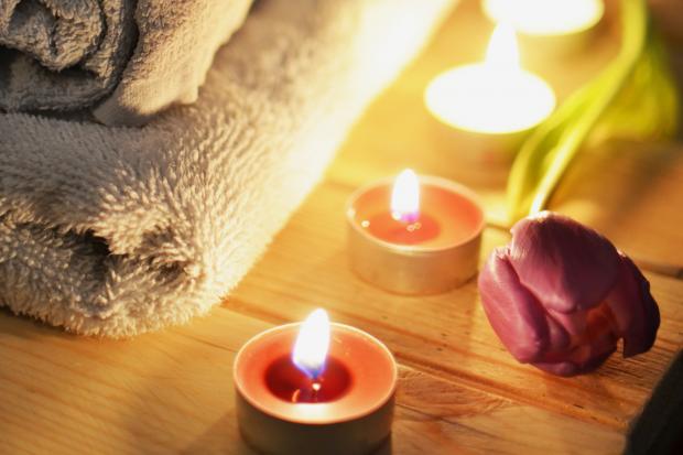 Bournemouth Echo: A pile of towels, candles and a tulip. Credit: Canva