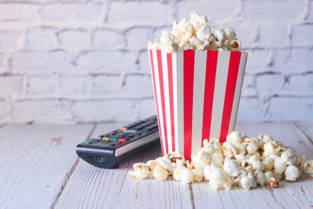Bournemouth Echo: A box of popcorn and a TV remote (Canva)