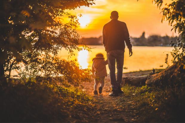Bournemouth Echo: Father and child walking together at sunset. Credit: Canva