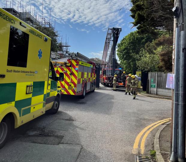 Bournemouth Echo: Casualty being rescued by fire and ambulance services after building site incident in Wimborne Road, Poole