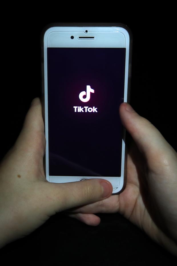 Bournemouth Echo: A person with TikTok open on their phone. Credit: PA