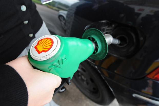 A person fills up at a petrol station