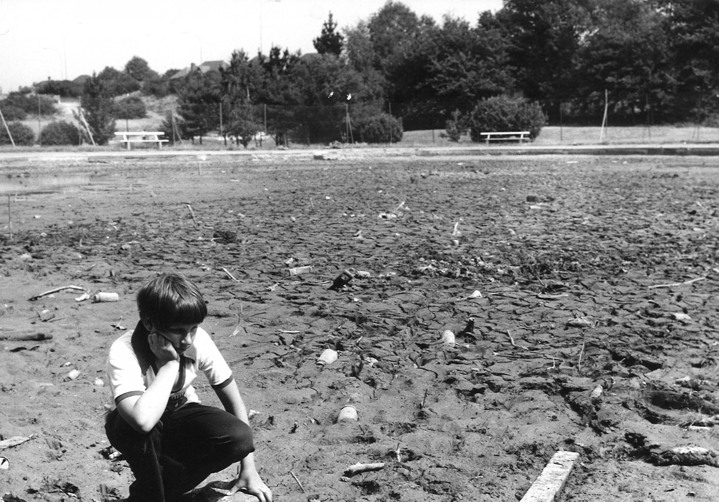 Stephen Bicknell, 11, by the pond at Queens Park golf course which ran dry for the first time in 40 years during a severe drought in August 1976..
