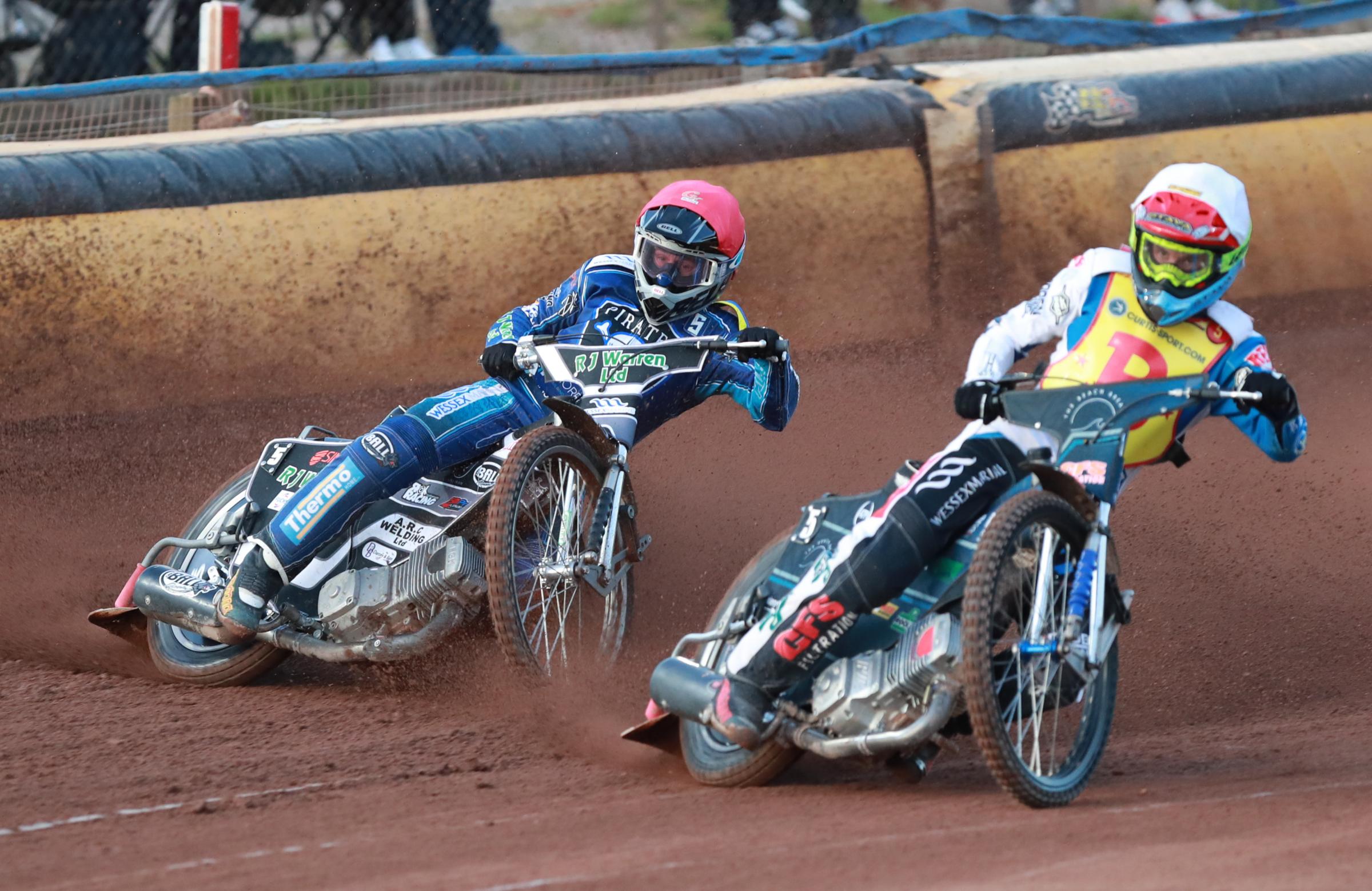 Poole Pirates v Birmingham Brummies in Championship Speedway at Wimborne Road. heat 4 - Danny King ( red) and Nathan Ablitt ( blue).