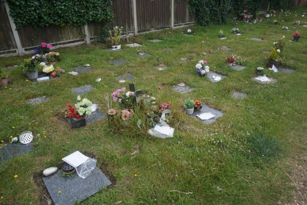 Bournemouth Echo: Decorated graves with removal notices at St Mark's Church, Talbot Village