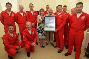 Pic by Corin Messer. Day three of the Bournemouth Air Festival and bad weather seriously affects the program of events.  The Red Arrows present a signed photograph to Pete and Linda Thornton at their fundraising annual dinner.