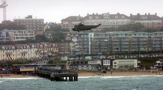  Bournemouth Air Festival Day Three - Day on RFA Largs Bay  - A Sea King helicopter  flies over Boscombe Pier