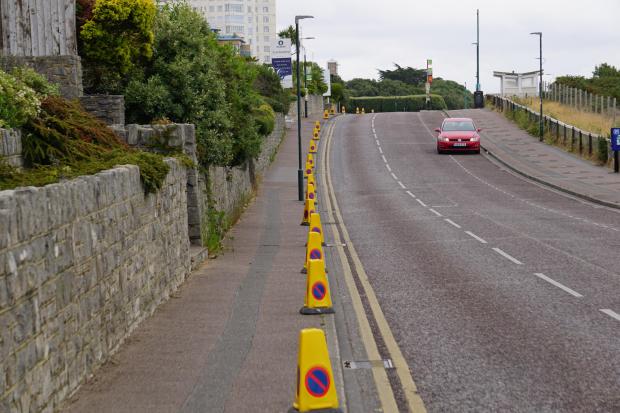 Traffic cones placed on pavement to stop illegal parking at East Overcliff Drive, Bournemouth