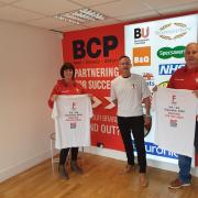 Operations Manager Wendy King and Merchandise Manager Paul Chapman, right, receiving printed t-shirts from BCP Media managing director Ian Shenton ahead of Paul's fundraiser