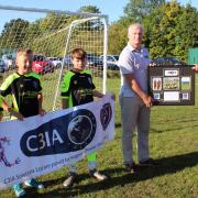 Matt Horan (left) receives a presentation plaque from Greg Partridge, manager of Dexter’s Under 11 Lions, with three of the players looking on