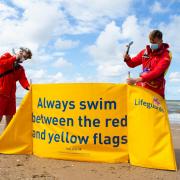 Rhyl RNLI Lifeguards George Davies and Matty Jones putting up windbreak. Picture: RNLI