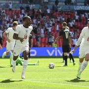 England's Raheem Sterling, left, celebrates after scoring his side's opening goal during the Euro 2020 soccer championship group D match between England and Croatia at Wembley stadium in London, Sunday, June 13, 2021. (Glyn Kirk/Pool Photo via