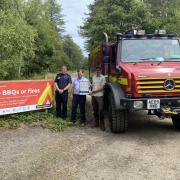 The new signs telling people that BBQS and fires are banned. Mike Radice - recreation ranger Forestry England, John Newcombe community safety Dorset Council, and Stephen Nicol DWFRS Picture: Dorset Council