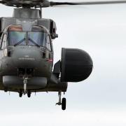 Royal Navy Merlin Mk2 helicopter in flight, with distinctive radar dome.
