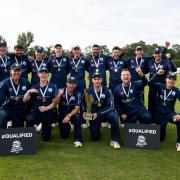 Brad Currie (back row, third from right) celebrates with his Scotland teammates after securing their spot at next year's T20 World Cup