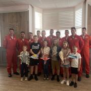 The children pictured among the Red Arrows Pilots