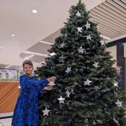 Forest Holme Hospice Charity Supporter Tiff Watson puts a star on the Tree of Remembrance