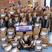 Soldiers and students pack Christmas boxes for kids with overseas parents