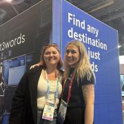 Ellen Stokes, left, and client on the what3words stand in Vegas
