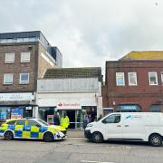 Police and forensics seen outside Santander after late night break-in.