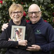 Linda and Pete Thornton with a portrait of their son  Lt John 'JT' Thornton RM
