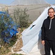 Ahmed lives in a tent with his parents with his other family members nearby.