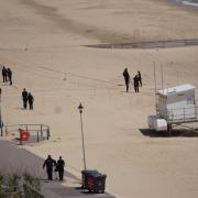 Murder probe enters third day after woman stabbed on beach - updates
