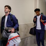 United States' Christian Pulisic, left, Tyler Adams, center and Ricardo Pepi, right arrive with teammates for the World Cup soccer tournament in Santa Ana, Calif. (AP Photo/Caroline Brehman)