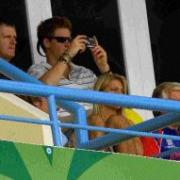 TAKE YOUR SEATS: There are seats aplenty for the affluent fans of Australia, New Zealand and England  and even for royal visitors such as Prince Harry, pictured above taking a quick snap while watching England against Australia at the Sir Vivian Richards
