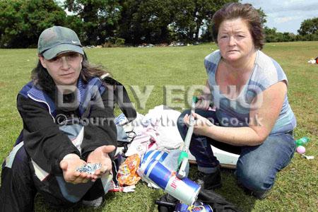 Rubbish left behind after travellers move on from Duck Lane playing fields in Bournemouth. Local residents Fiona Henry and Julie Cummings.