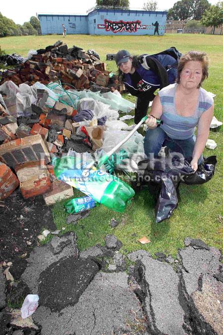 Rubbish left behind after travellers move on from Duck Lane playing fields in Bournemouth. Local residents Fiona Henry and Julie Cummings clean up some of the mess themselves.