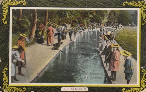 Old coloured postcard of children by the Bourne Stream in the Bournemouth Pleasure Gardens submitted by G Gulliver. Postmarked 1915.