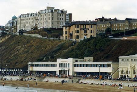 Anthony Heaney  took this photograph of the West Cliff circa 1984. The imposing building on the left is the Highcliff Hotel and the Bay Hotel is centre. 