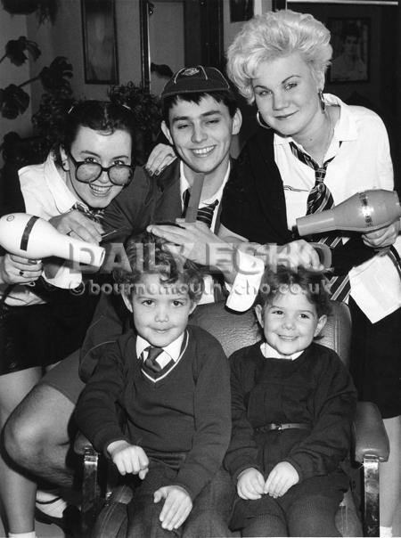Bournemouth Headquarters hairdressers staff, Yuette Wilden, Paul Skelton and Susie Hoddinott dress up and offer cheap childrens haircuts in aid of GOSH. Daniel and Sophie Morris first ones to be cut,1988.