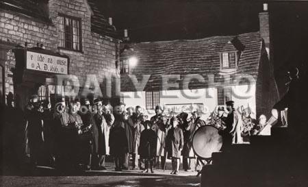 Corfe Castle band played carols and brought good cheer outside the Ye Olde Tea House and the Castle Cafe in 1953.