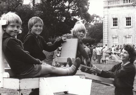 In 1981 large crowds visited Grange House fete, raising funds for Swanage and Herston Football Club. Three brothers, David,3, Mark,8, and Christian Hawkins, 7, of Holton Heath await the trolley ride operated byn Mrs Janet Enock of Swanage.