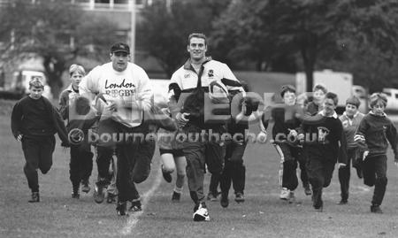 Running With The Pack. Christchurch juniors pictured with rugby union international stars Richard Kinsey (centre left) and Lawrence Dallagio.