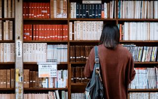 A student browsing books in the library. Credit: Canva