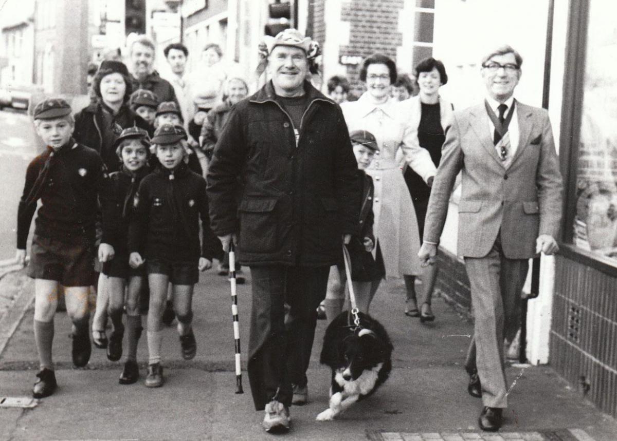 In October 1981 Hughie Dennett completed a sponsored walk in aid of the 1st Wareham Scouts to enable them to go on a trip to London. He is seen here with his dog leaving Wareham with the Mayor Cllr Maurice Pascall and the Cubs of the Wareham Scout Group.