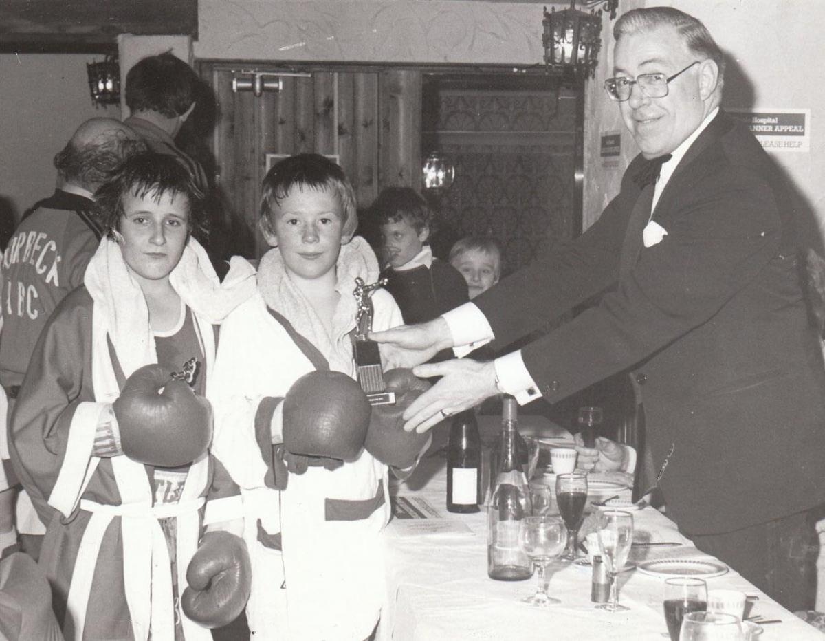 March 1981 Maurice Cooper of Wareham, right, received his trophy as the winner over Austin Williams of Bournemouth at the Purbeck Amateur Boxing Club show at the Durlston Court Hotel. 