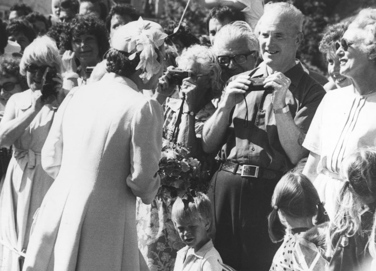 Queen Elizabeth II chat to her subjects during a walkabout in West Lulworrth on 28 June, 1984