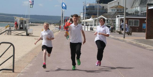 GET SET, GO! Students take part in the torch relay along the seafront