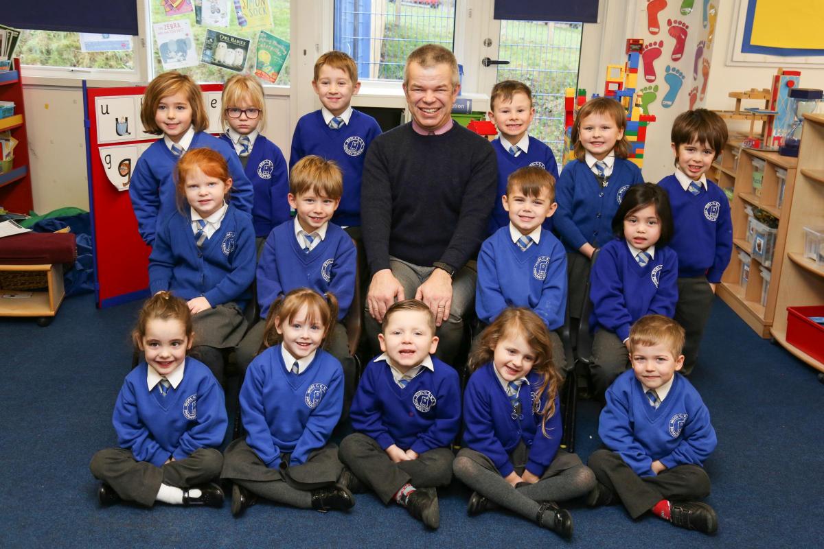 Reception children in Squirrel class at Wool C of E Primary School with teacher Jonathan Charman.